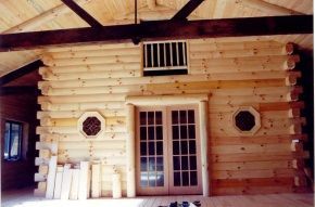 The inside of a log cabin with french doors