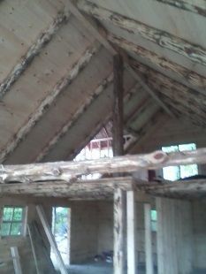 A room with a wooden ceiling and a wooden floor.