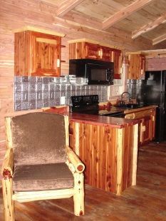 A kitchen with wooden cabinets and a chair