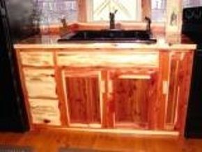 A kitchen with a sink and cabinets made of wood.
