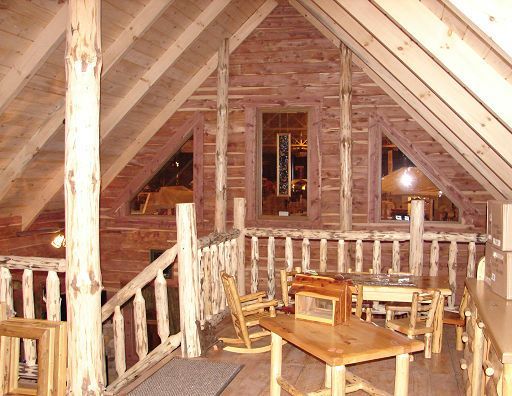 A wooden room with a table and chairs in it