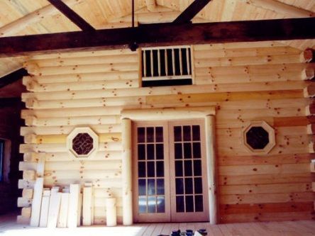 The inside of a log cabin with french doors