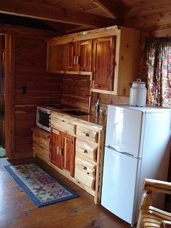 A kitchen with wooden cabinets and a white refrigerator