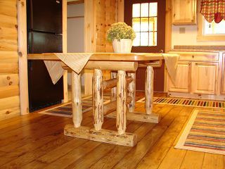 A wooden table with a potted plant on top of it in a kitchen.