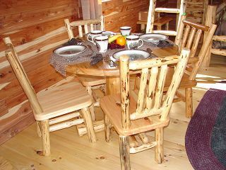 A wooden table with plates and cups on it