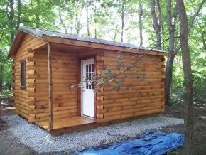 A small wooden cabin in the middle of a forest.
