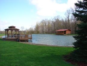 There is a gazebo in the middle of a lake.