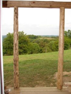 A view of a grassy field through a wooden frame