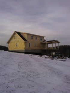 A house in the middle of a snowy field