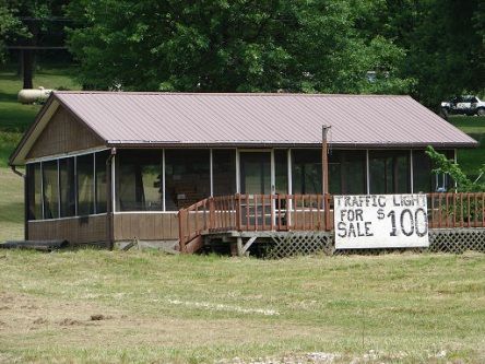 A house with a screened in porch is for sale for $ 100