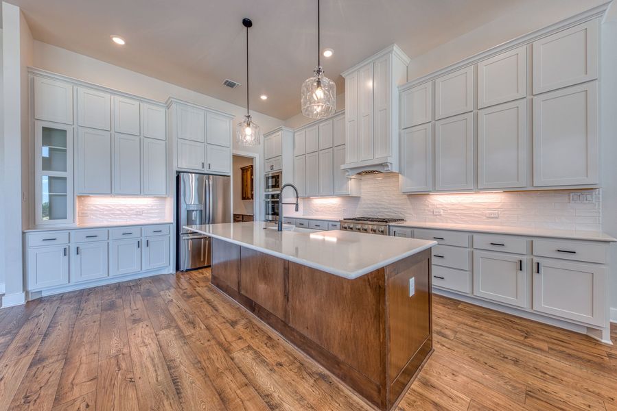 There is a large island in the middle of the kitchen.