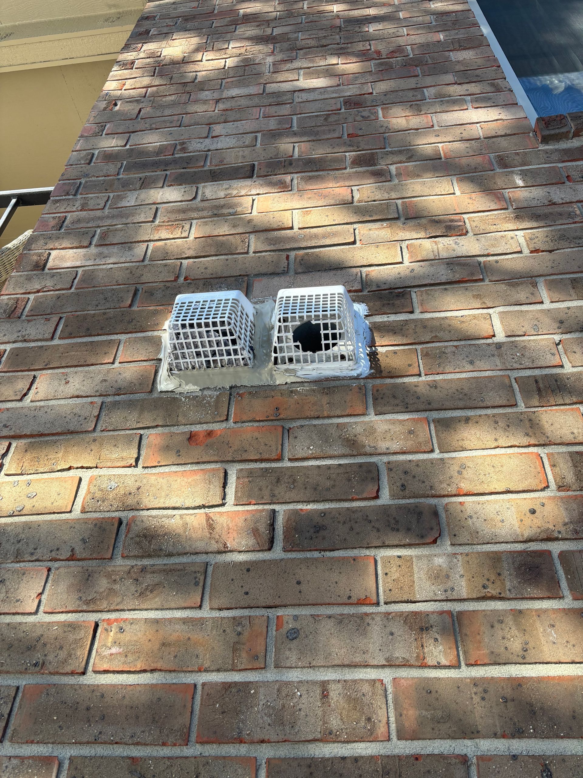 A close up of a brick wall with a hole in it.