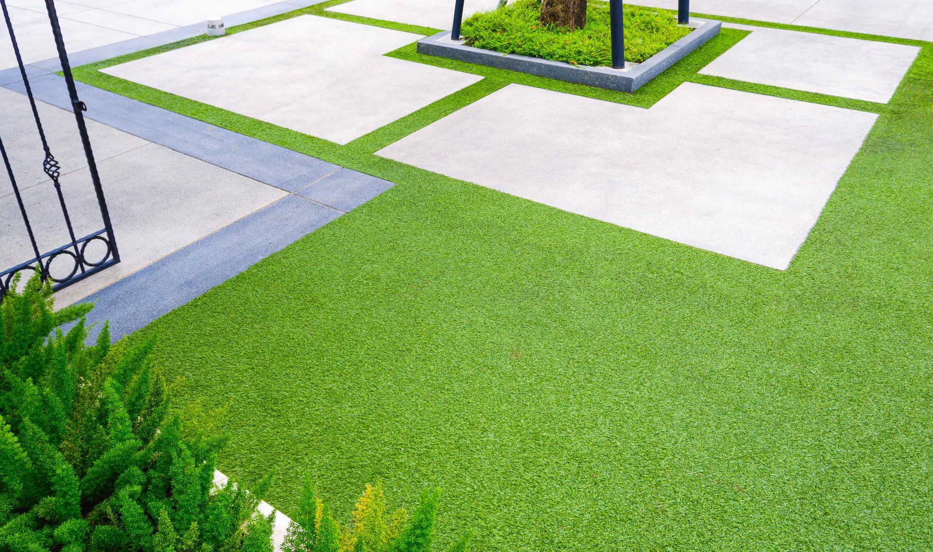 Affordable Artificial Turf Around Smooth Paver Stones In Yard
