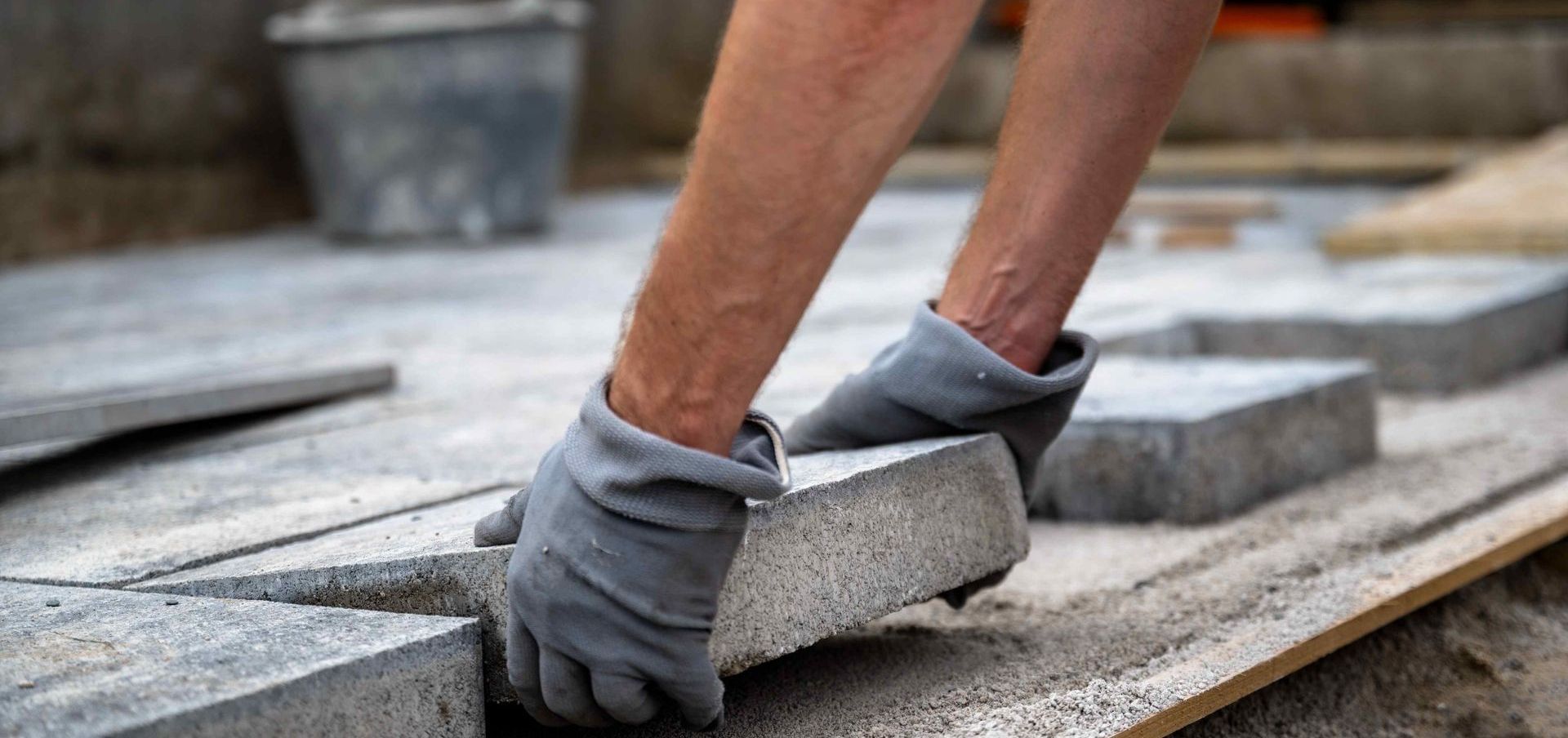 Man Installing DIY Patio With Concrete Pavers At Home