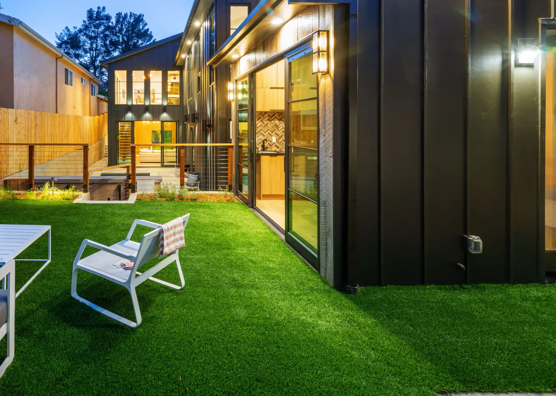 Small Backyard With Lawn Chairs On Artificial Turf