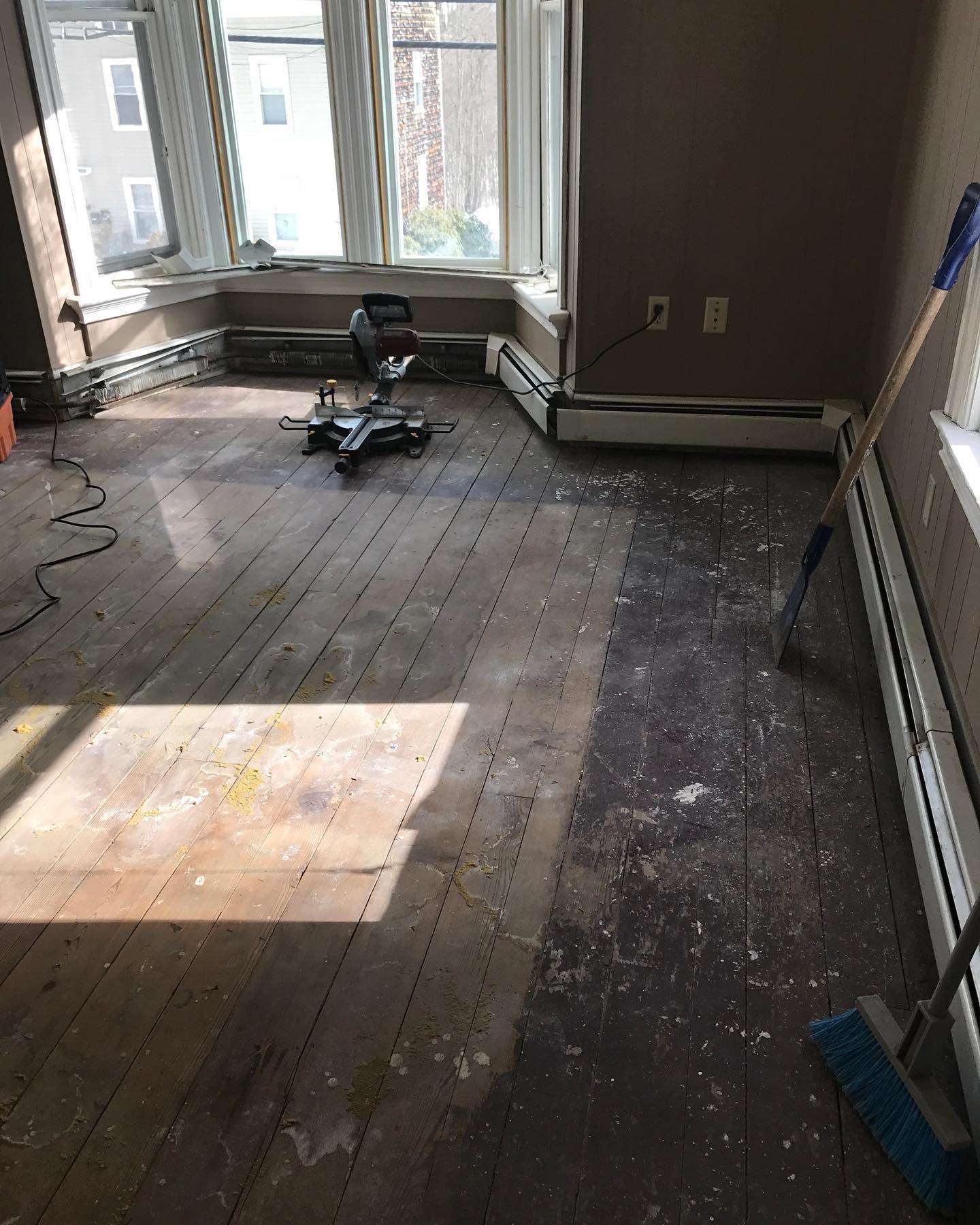 A room with a wooden floor and a window.