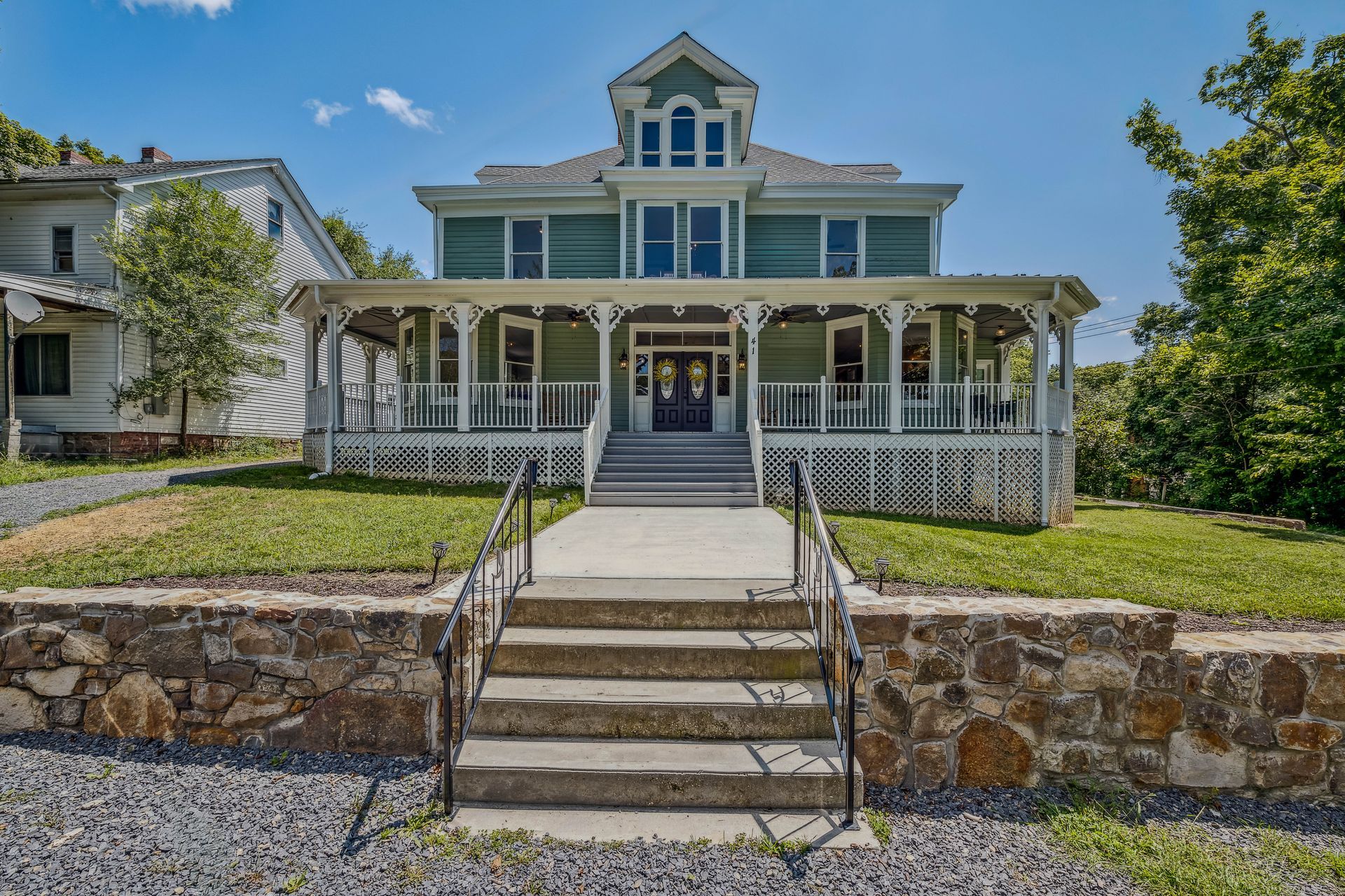 A large house with stairs leading up to it
