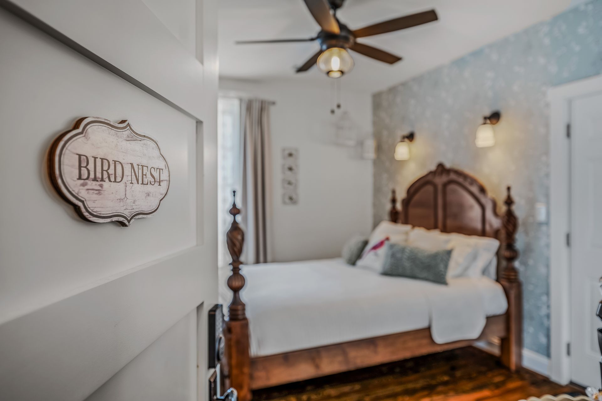 A bedroom with a bed and a sign that says bird nest