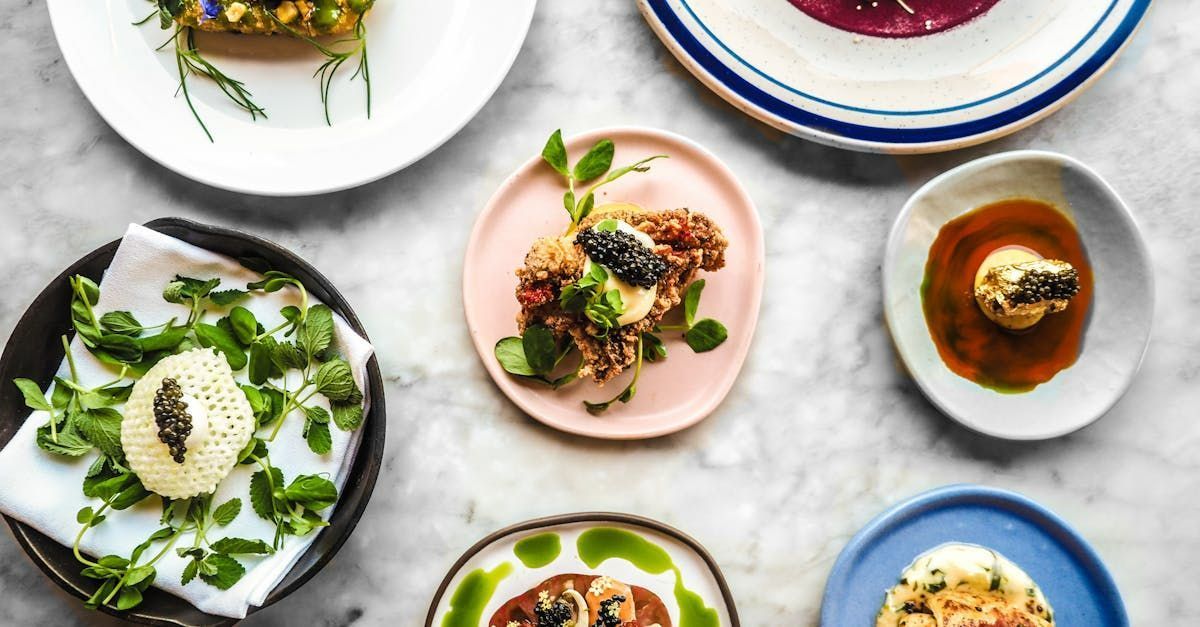 A table topped with plates and bowls of food.