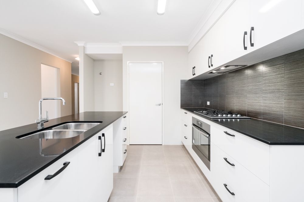Modern Kitchen With White Cabinets — Brayden Stewart Building In Forster, NSW