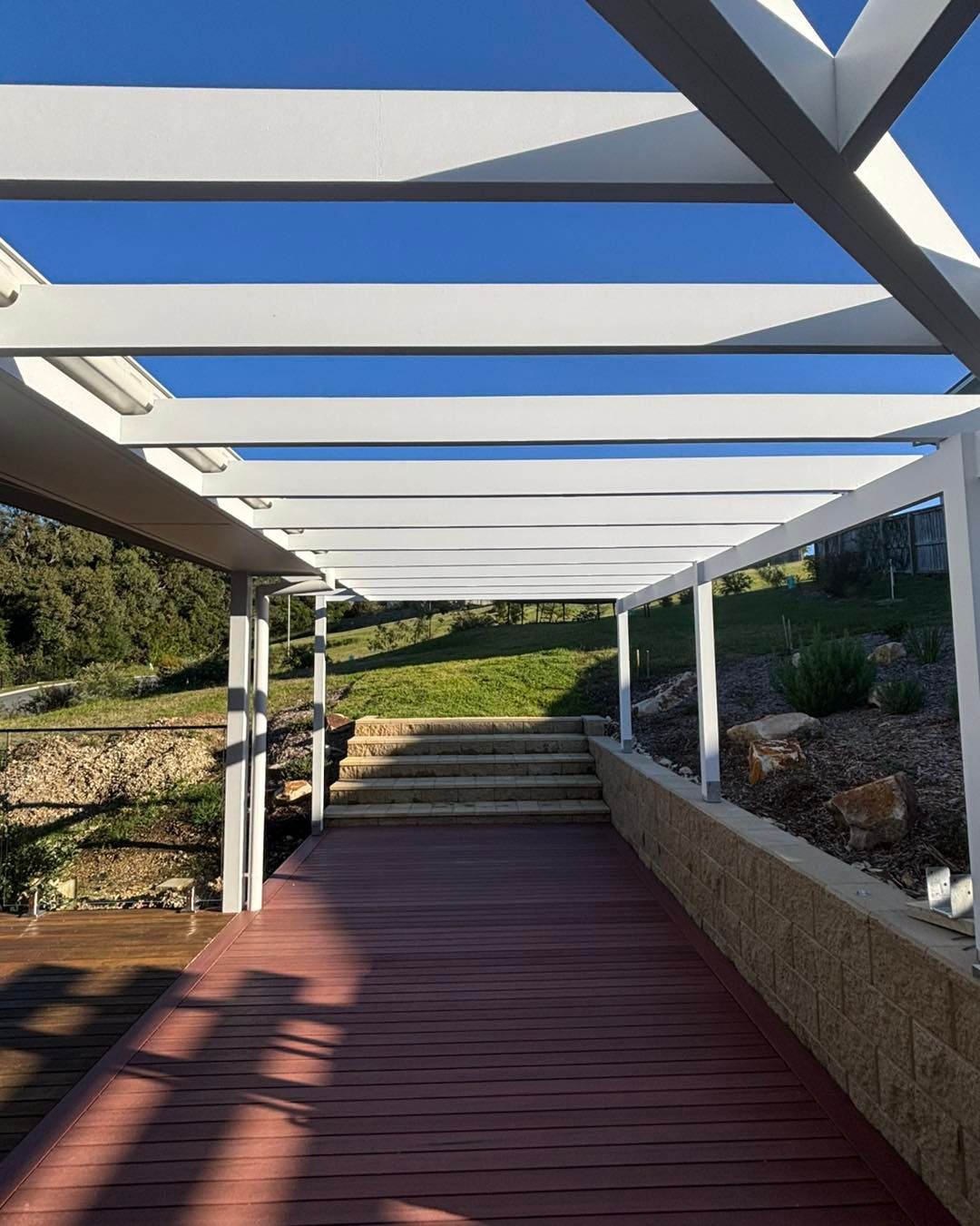 White Pergola Over a Wooden Walkway Leading to Stone Steps — Brayden Stewart Building In Tuncurry, NSW