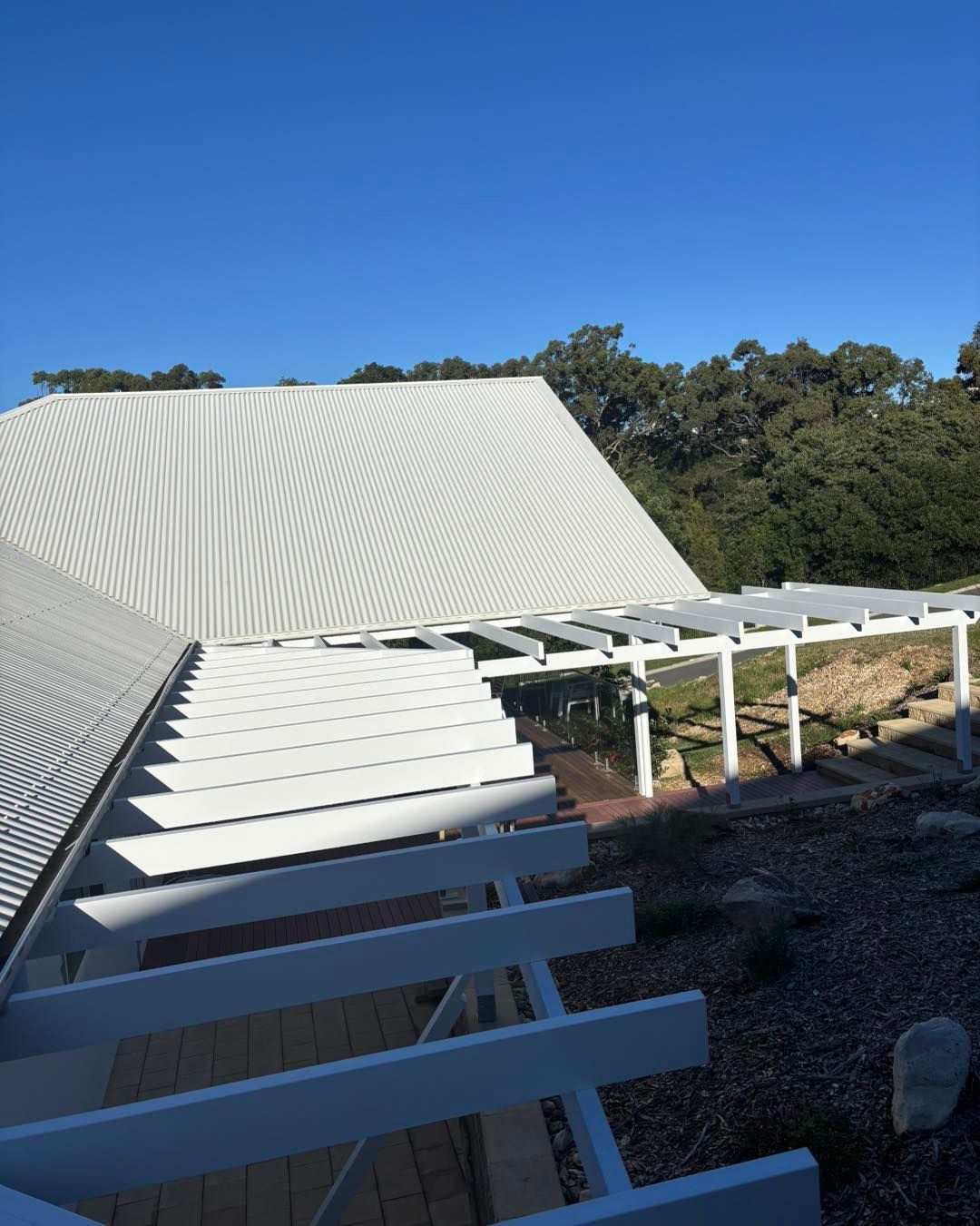 White Pergola and Corrugated Metal Building Roof — Brayden Stewart Building In Tuncurry, NSW