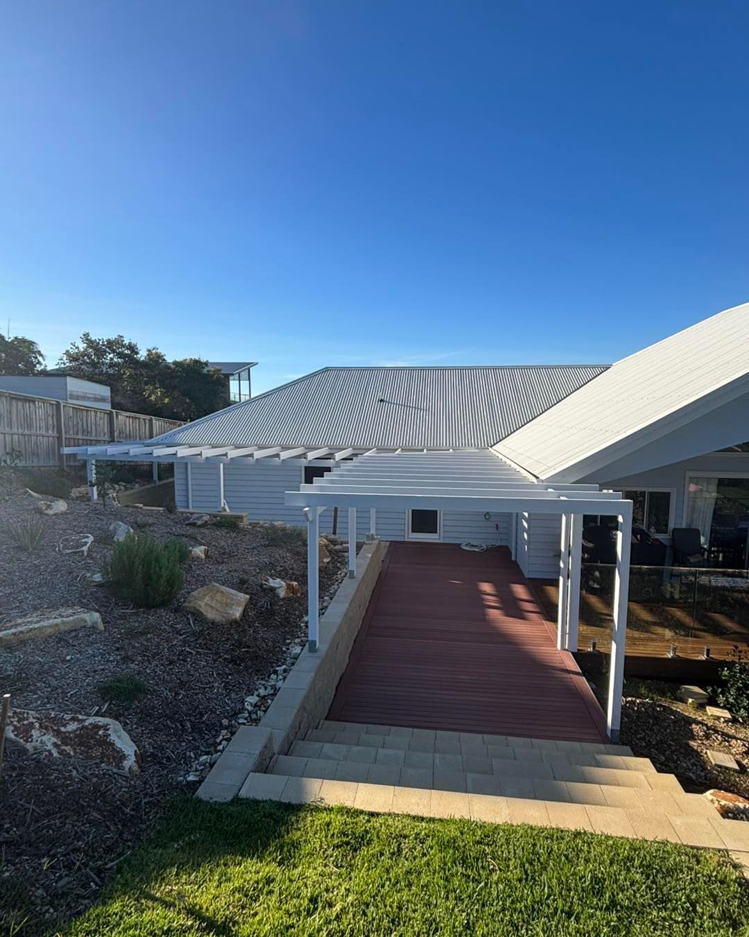 White House With a Wooden Deck and Pergola — Brayden Stewart Building In Tuncurry, NSW