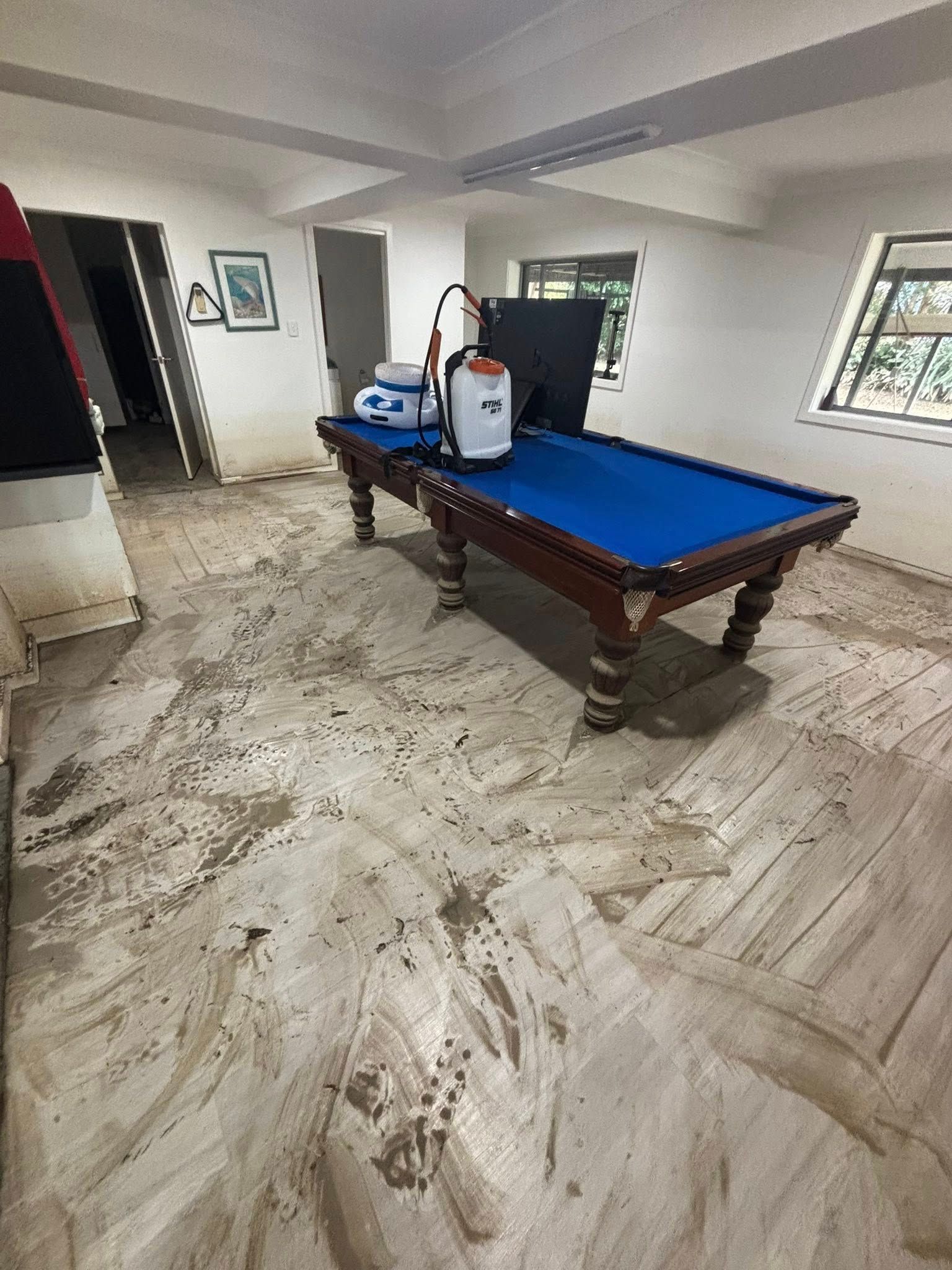 Room With a Blue-felt Pool Table; Cleaning Equipment Sits Atop the Table — Brayden Stewart Building In Tuncurry, NSW