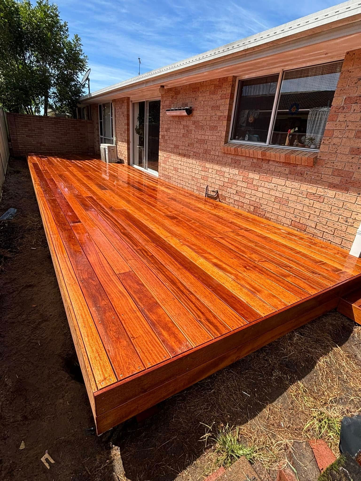 Wooden Deck Next to a Brick Building — Brayden Stewart Building In Forster, NSW