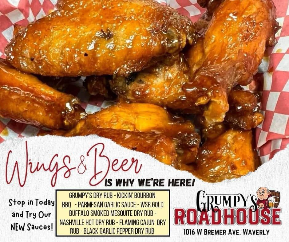 A sign for grumpy 's roadhouse advertising wings and beer