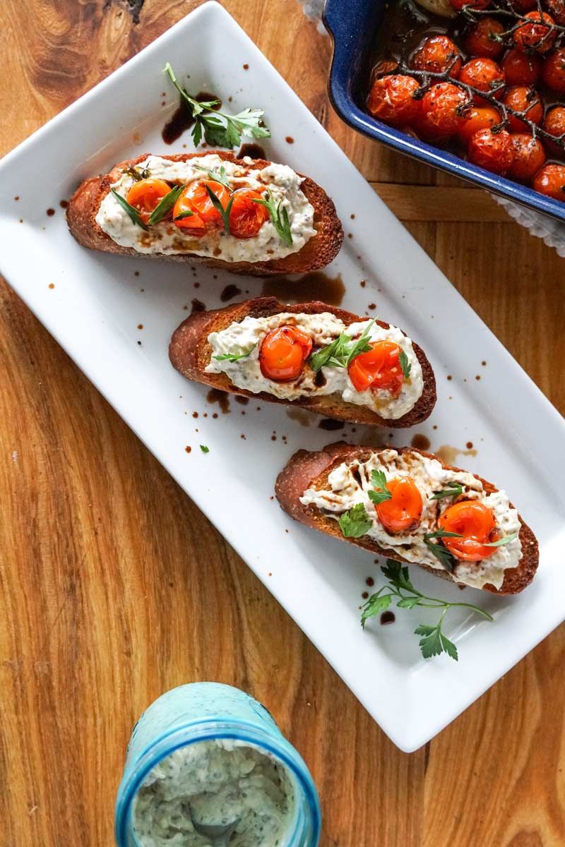 A white plate topped with three slices of bread and tomatoes.