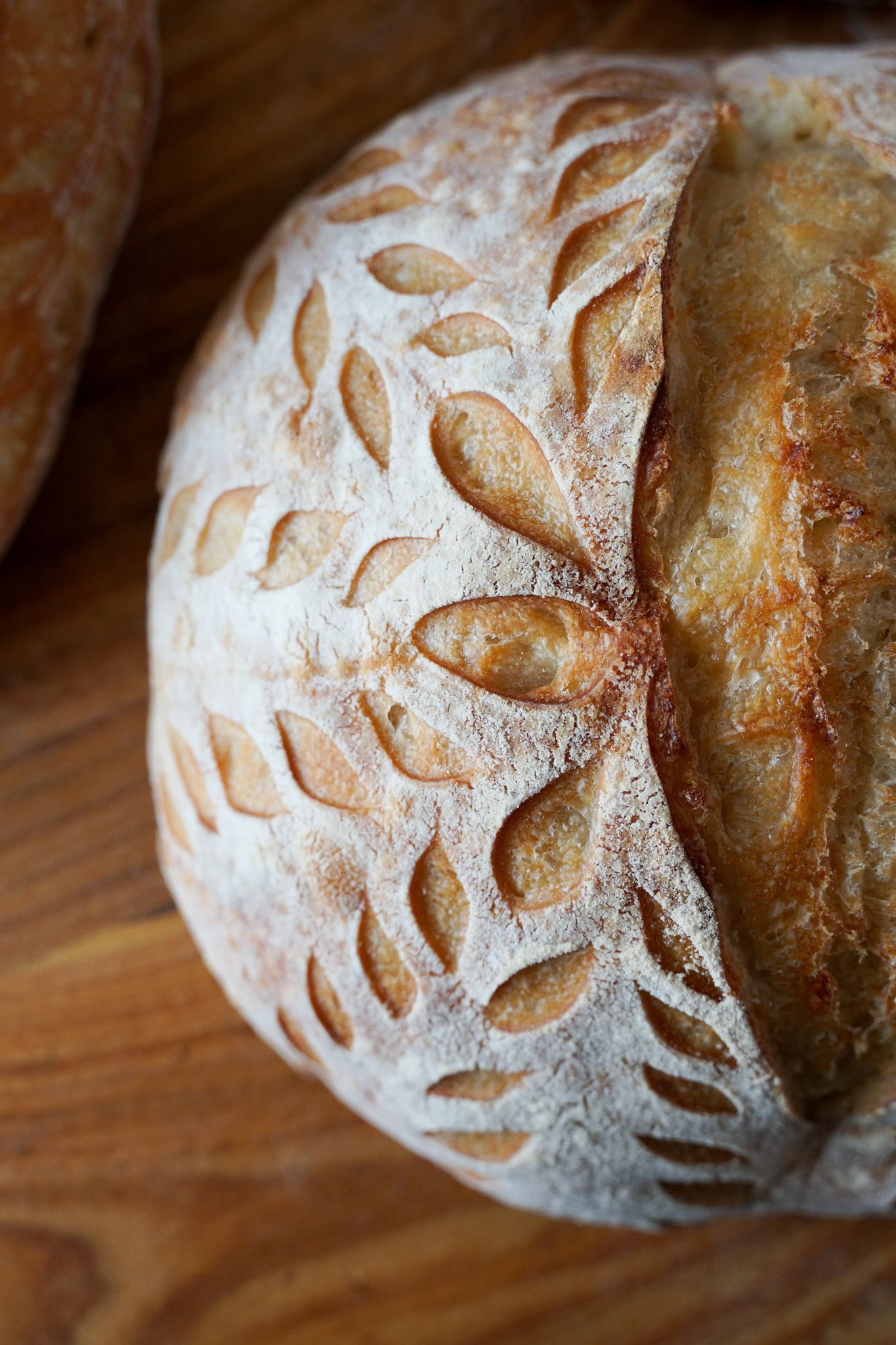 A loaf of bread is sitting on a wooden table.