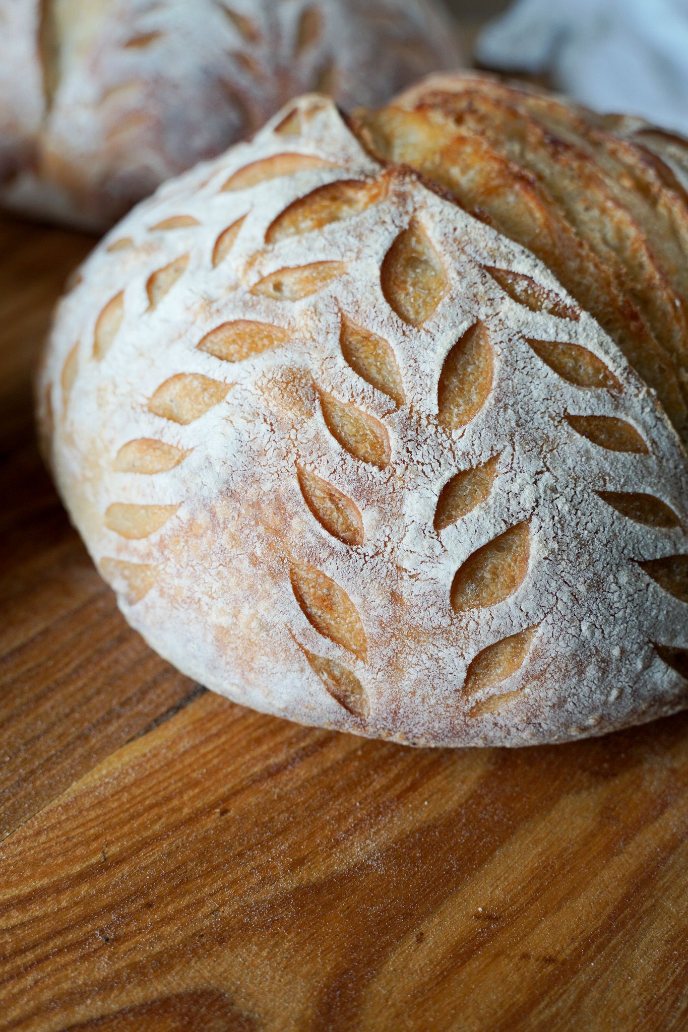 A loaf of bread is sitting on a wooden cutting board.