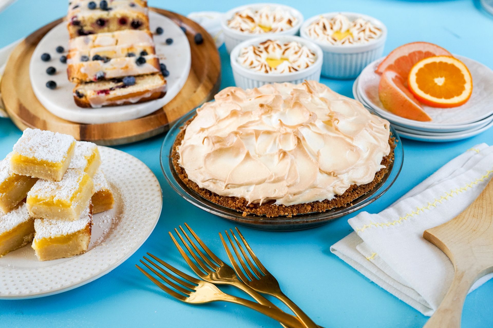 There are many different types of desserts on the table.