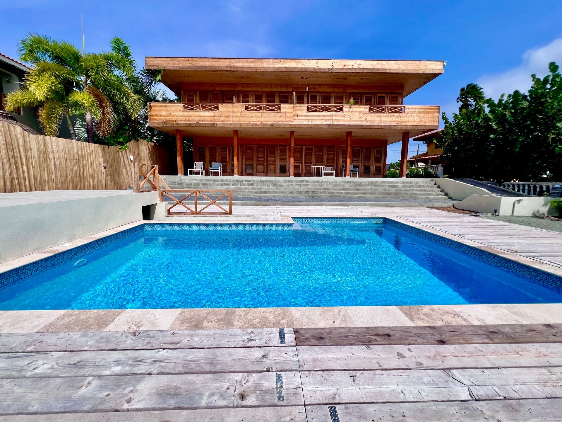 Modern eco lodge with swimming pool in Curaçao with ocean view and sun loungers and umbrellas for a relaxing stay