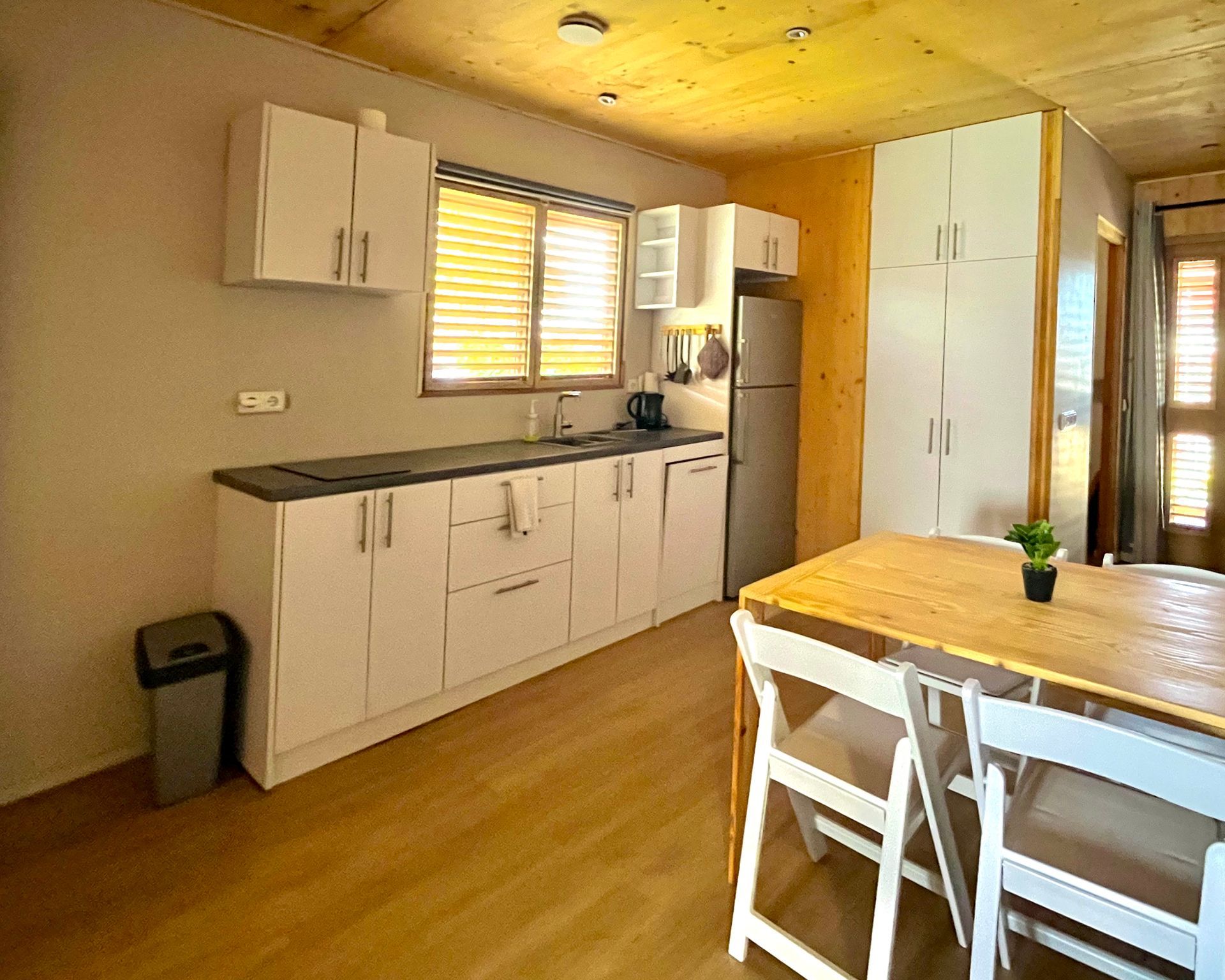 Modern oceanfront Eco lodge in Curacao with compact well-equipped kitchenette with wall mounted foldable table