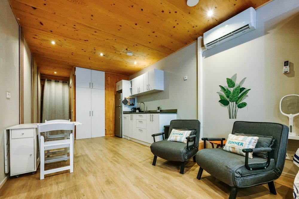 Cozy oceanfront studio in Curaçao with queen-size bed, kitchen area, and open terrace overlooking the Caribbean Sea