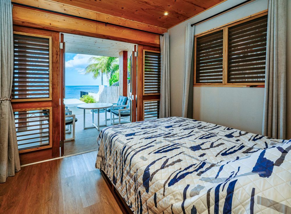 Modern oceanfront eco lodge in Curacao with private spacious bathroom, walk-in shower and natural finishes 