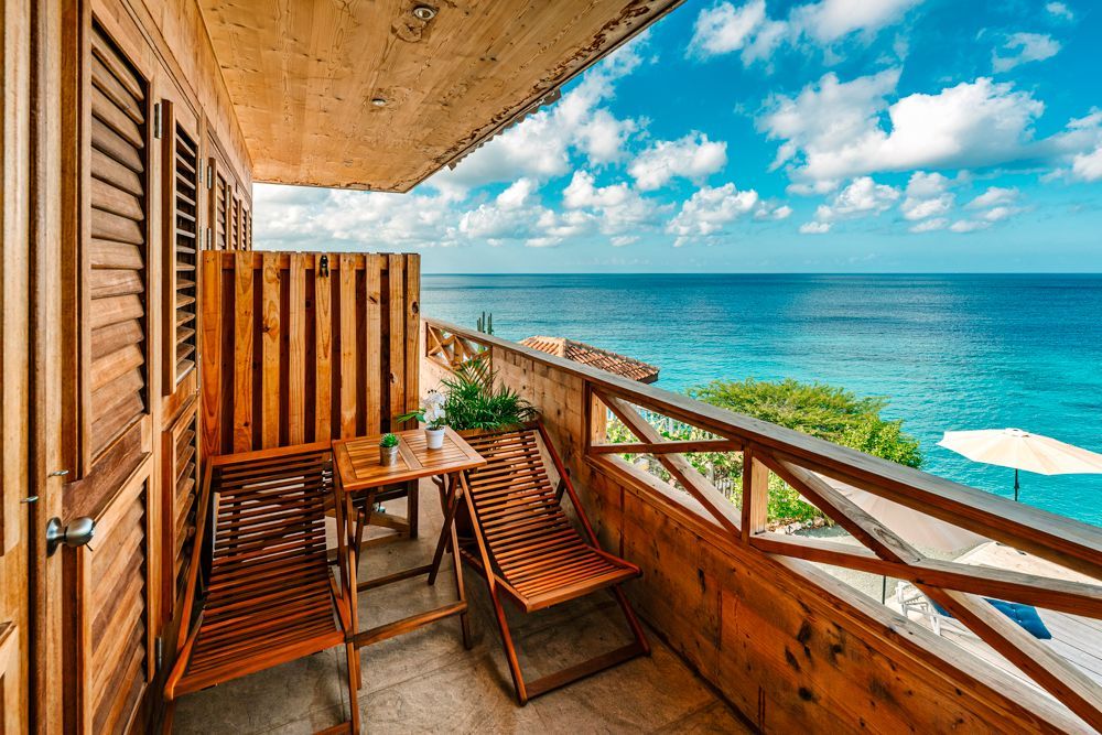 Oceanfront Suite with separate bedroom, a queen size bed, airconditioned, blackout curtains, with outside balcony