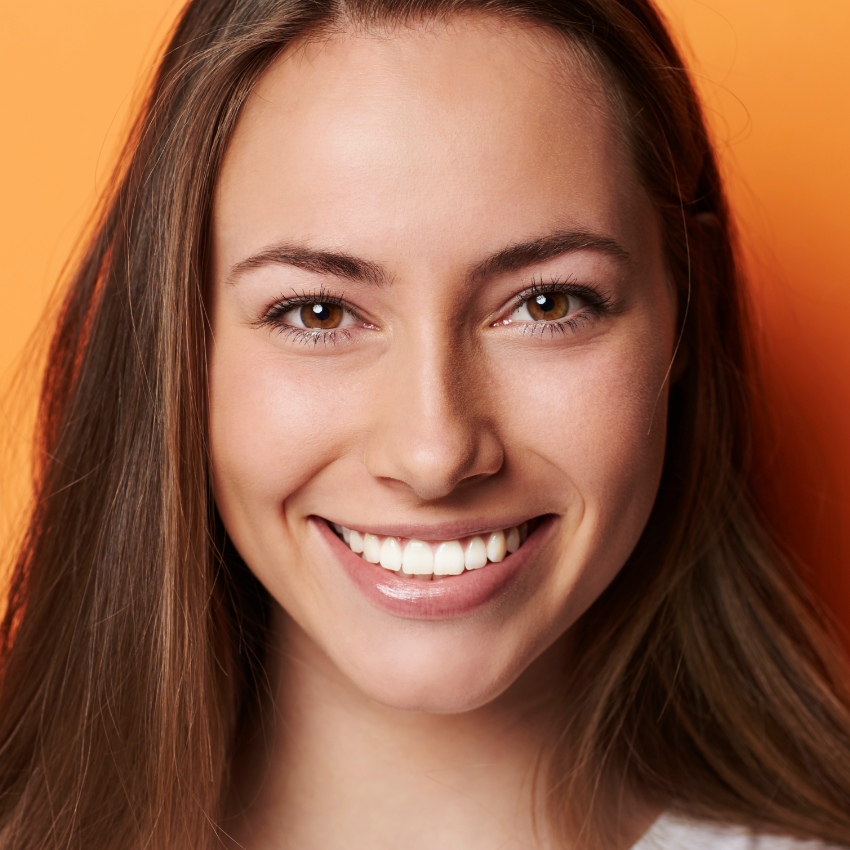 woman smiling, orange background