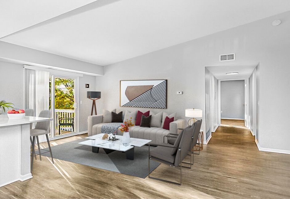 Living room interior with a sofa, coffee table, and access to a balcony.