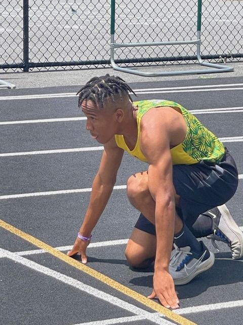 African American athlete prepares to start a race.