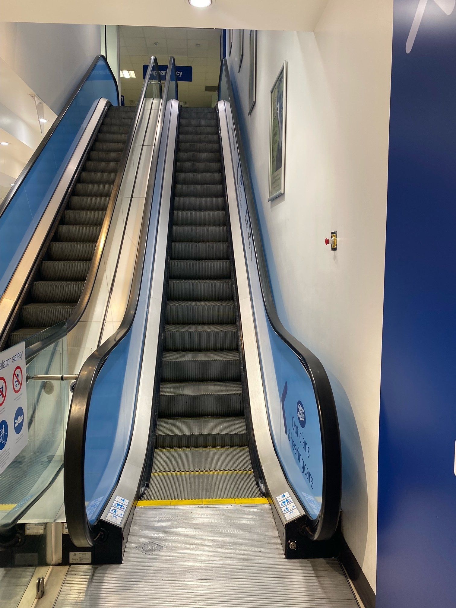 A blue and silver escalator in a building
