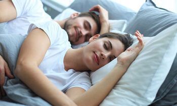 Happy Couple Sleeping On A Bed - Indianapolis, IN - Sleep Better Indy