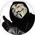 Person wearing a Guy Fawkes mask, black gloves, and hood, giving a thumbs up.