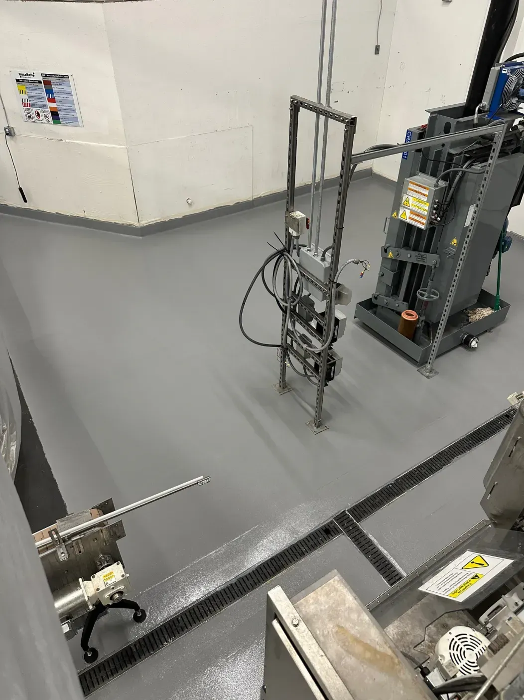 Gray factory floor with machinery and equipment.