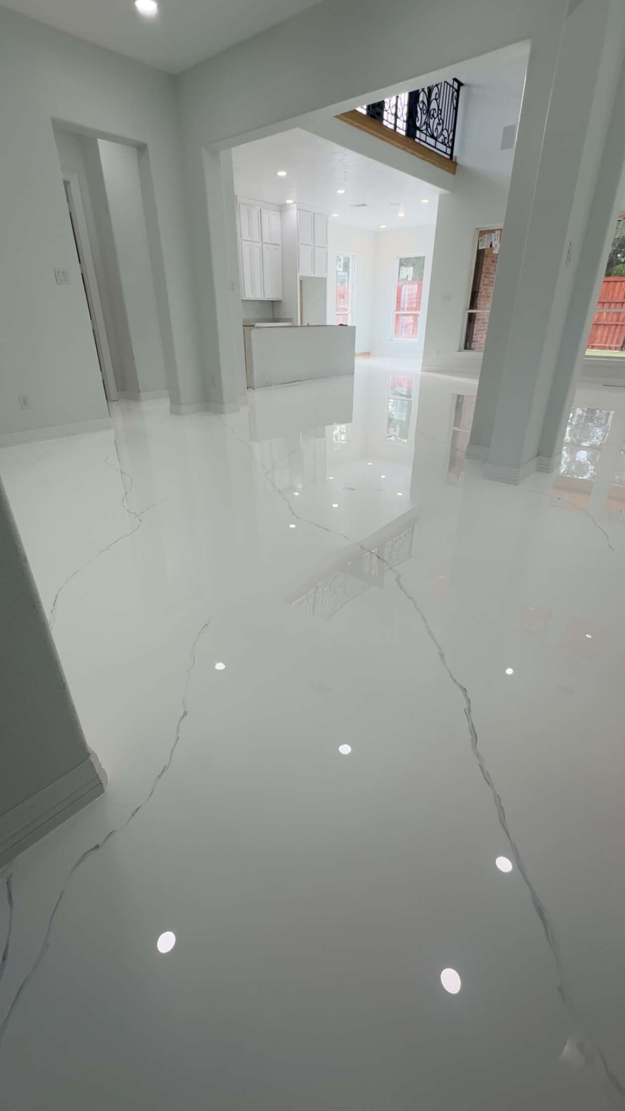 White glossy floor in a modern interior with white walls and natural light.