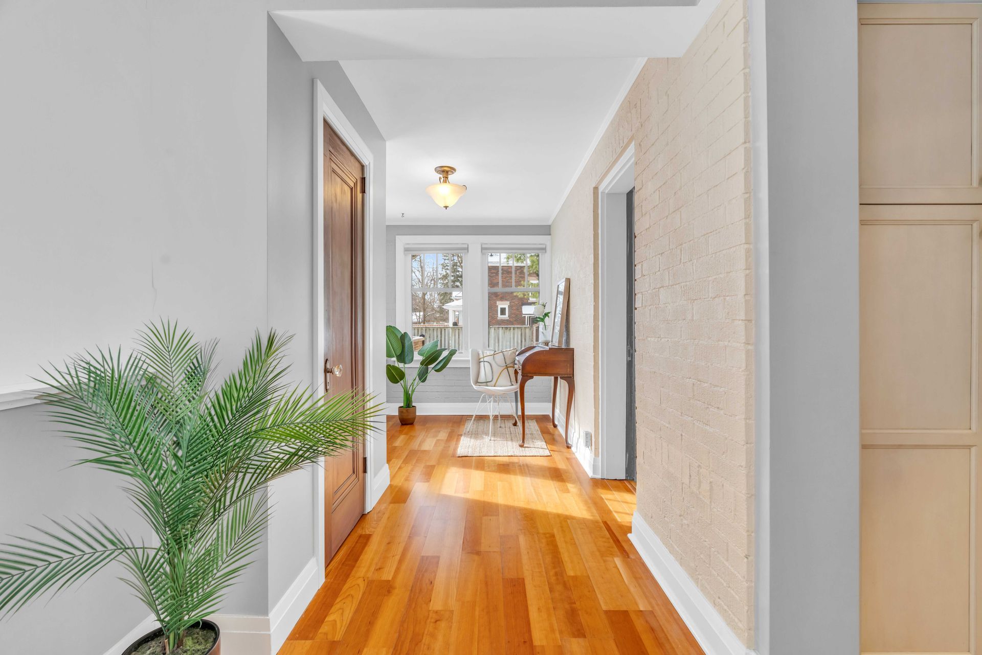 A hallway in a house with hardwood floors.