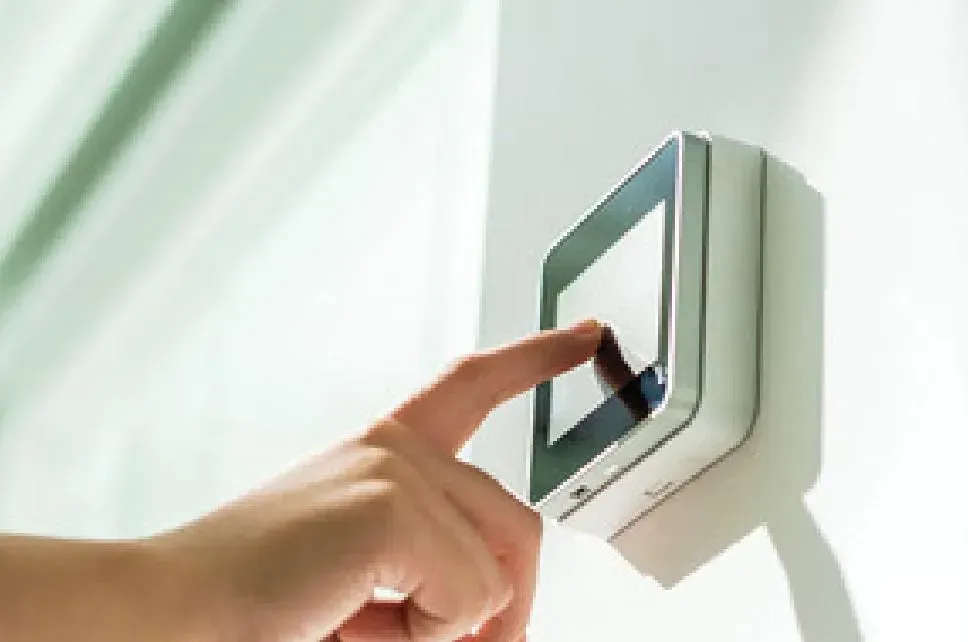 man setting thermostat