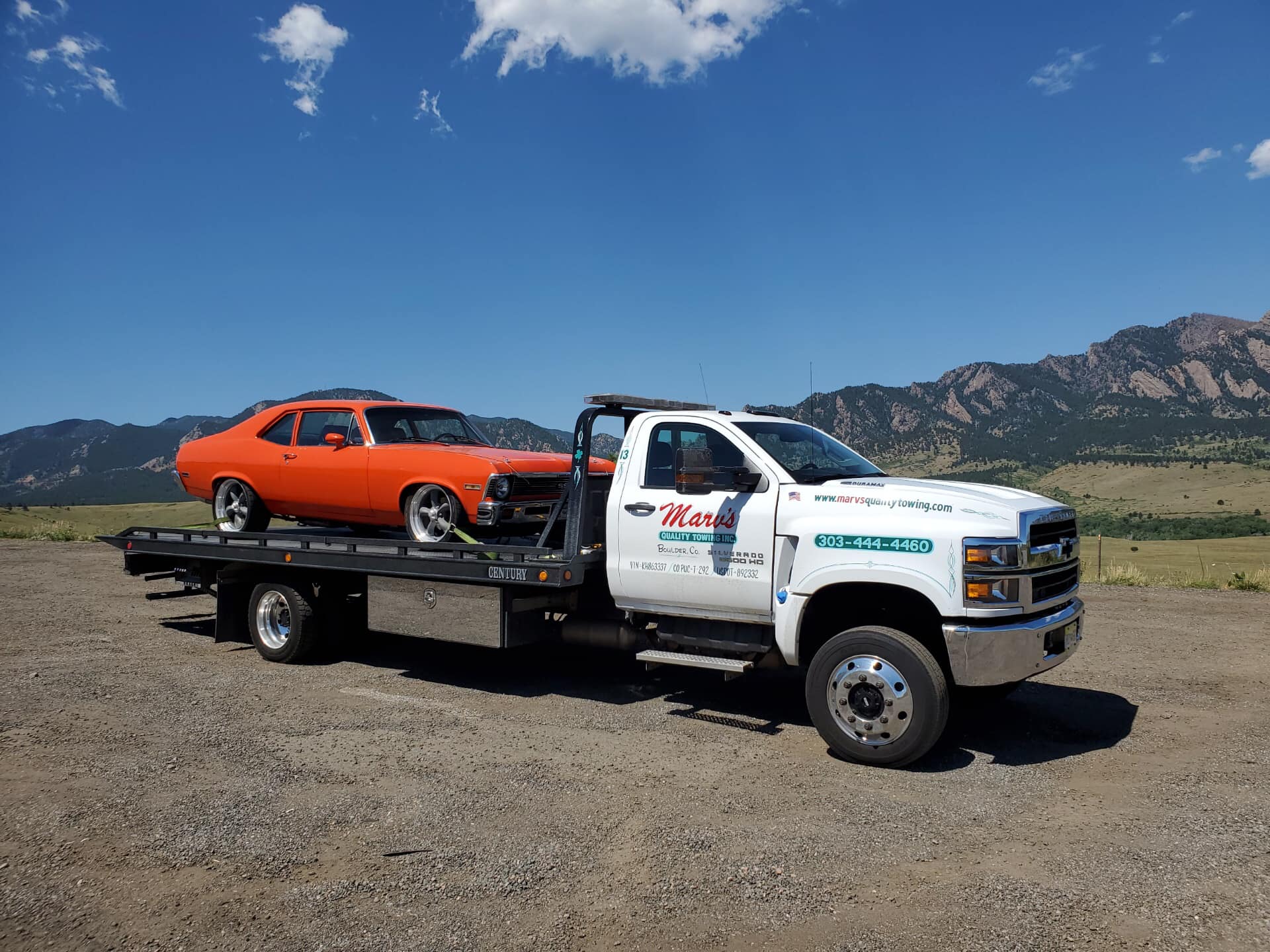 Towing a Red Car — Boulder, CO — Marv’s Quality Towing Inc